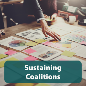 Organizing stick notes and papers on a table with "sustaining coalitions" text.